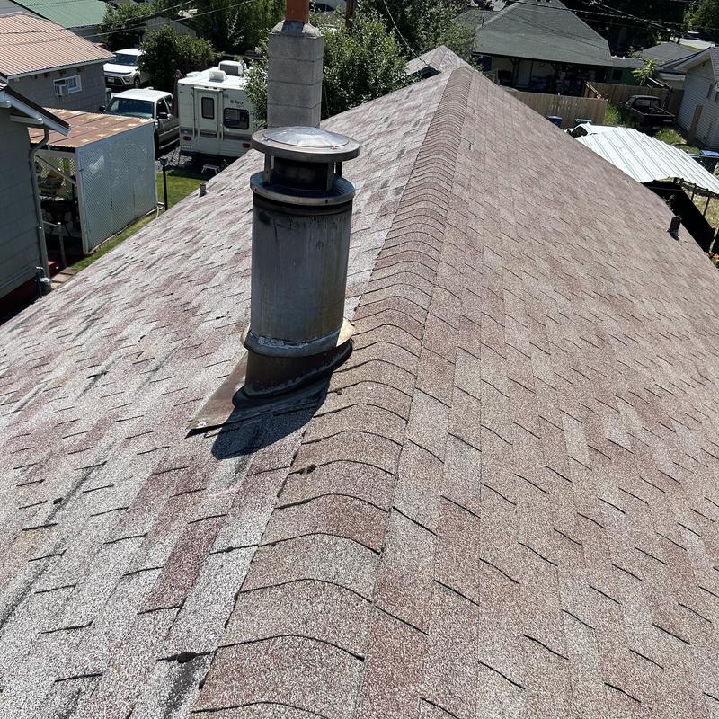 Asphalt shingle roof with vent pipe and chimney flashings Asphalt shingle roof with vent pipe and chimney flashings
