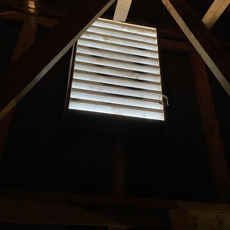 Attic vent with wood framing and slats