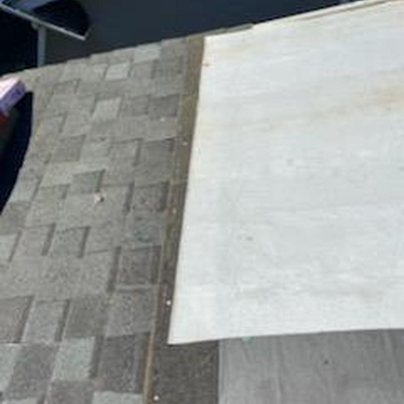 Roof underlayment installation next to old shingles