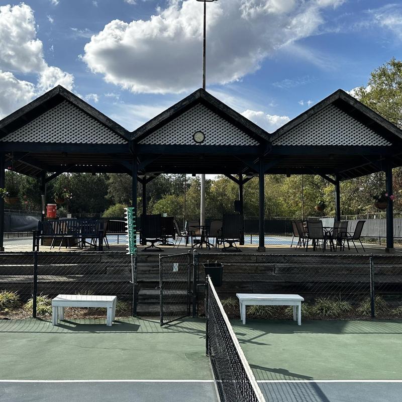 Tennis court wind screens with hurricane damage