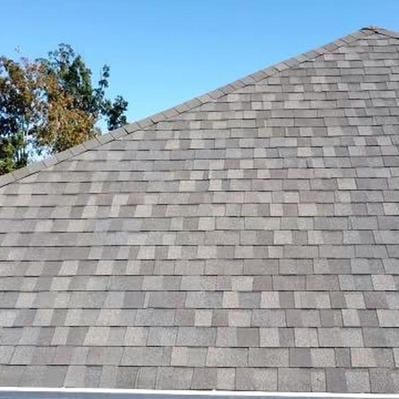 Asphalt shingle roofing with new pipe boot installation