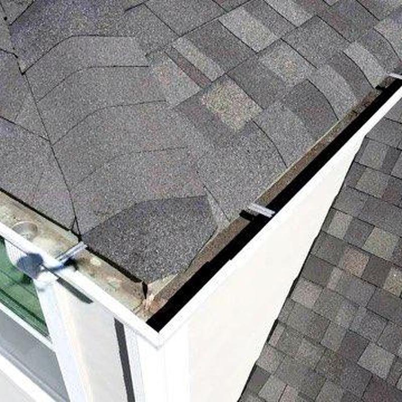 Asphalt shingle roof corner with gutter and flashing