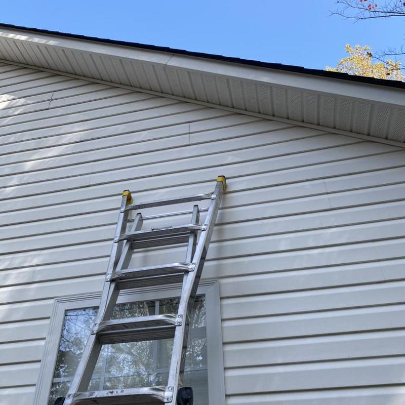 Metal bent fascia with ladder against house exterior
