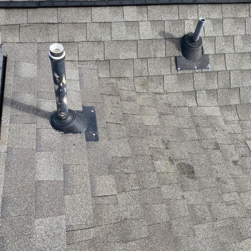 Roof vent flashing on asphalt shingle roof during repair