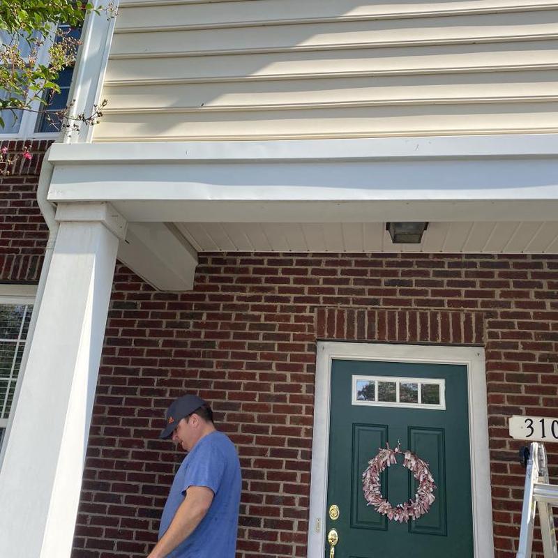 Metal fascia with vinyl siding above porch repair