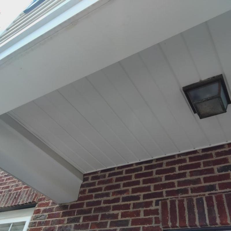 Metal fascia and vinyl siding on brick wall exterior