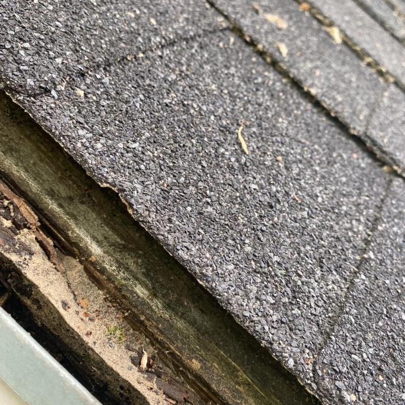 Shingles with insufficient overhang above gutter edge