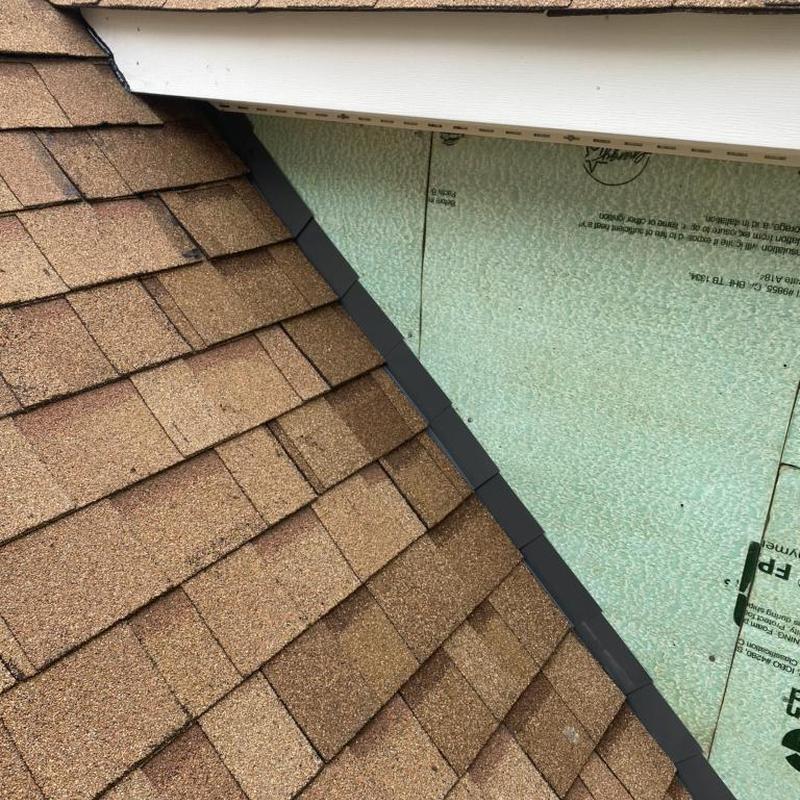 Step flashing installation behind siding on roof edge