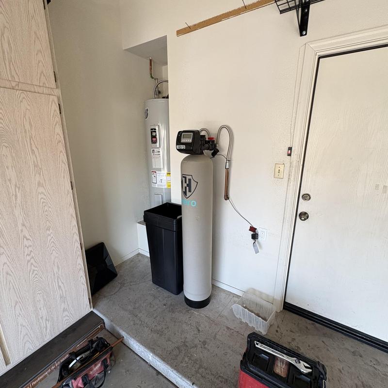 Water softener system with control valve in utility room