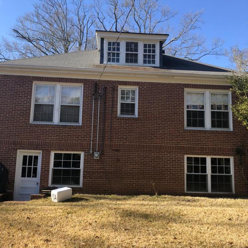 Asphalt shingle roof on brick house in daylight