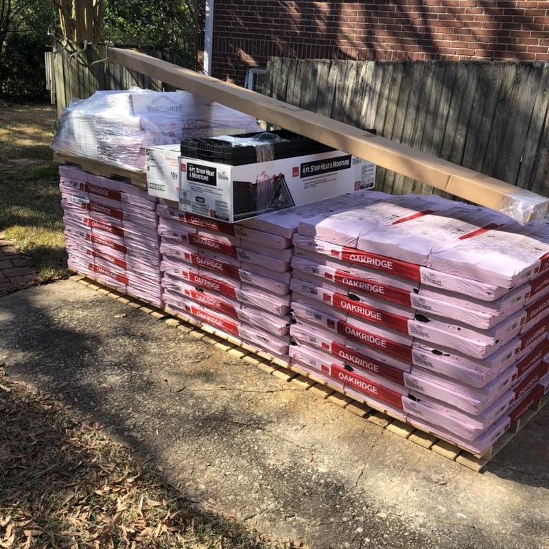 Owens Corning Oakridge shingles stacked on pallet outdoors