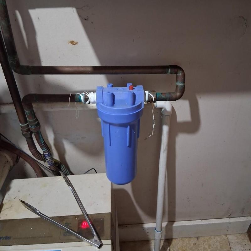 Under sink water filter housing with copper piping