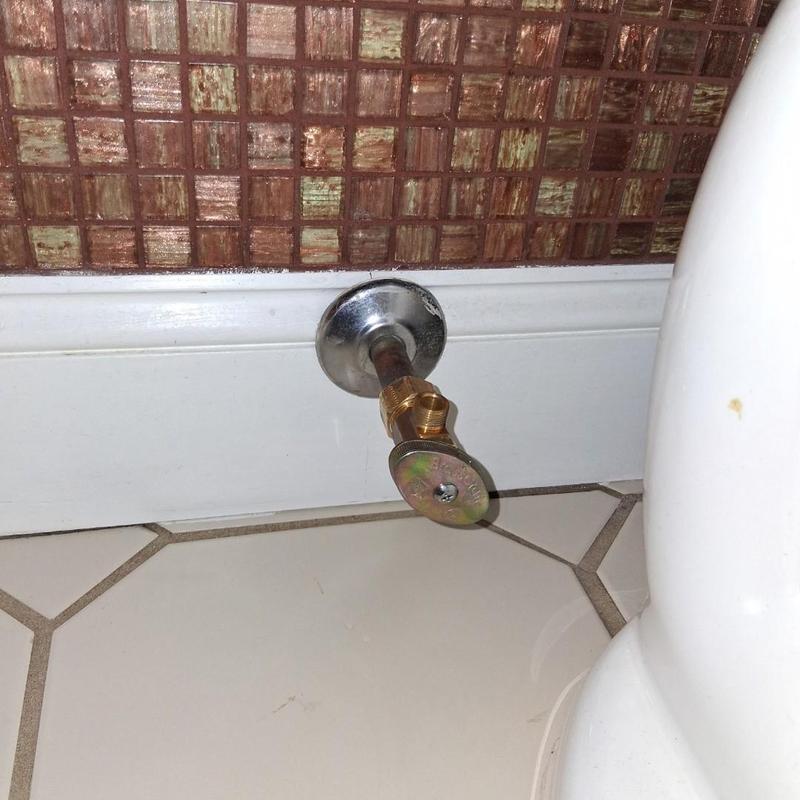 Toilet stop valve replacement near tiled wall and floor