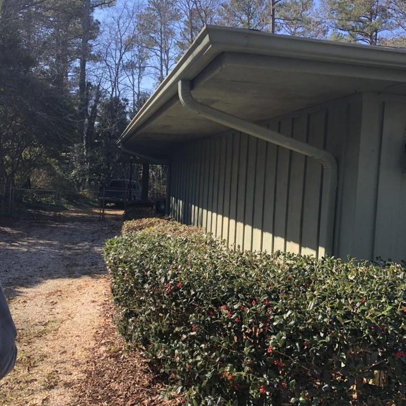 Gutter system with new downspouts on house side