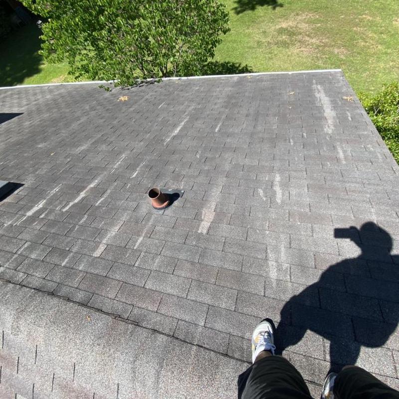 Asphalt shingle roof with visible wind and hail damage