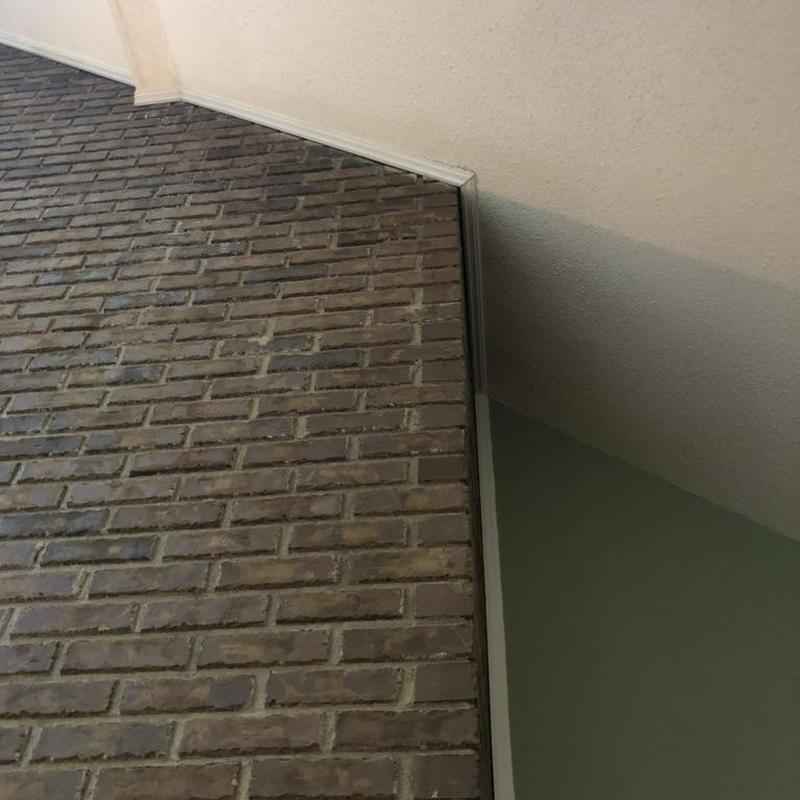 Brick chimney corner with ceiling and wall trim
