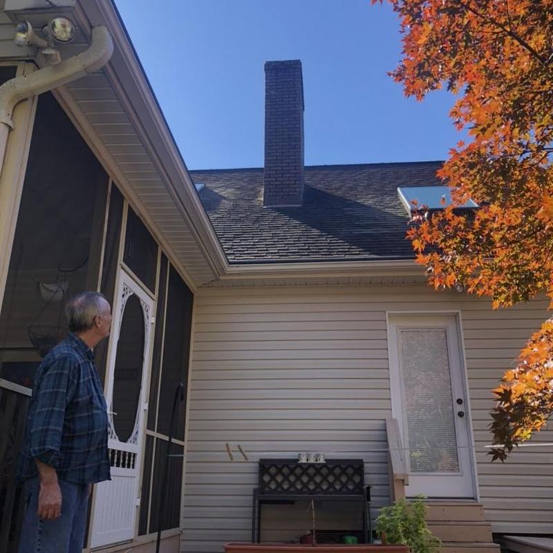 Asphalt shingle roof with chimney and gutter system