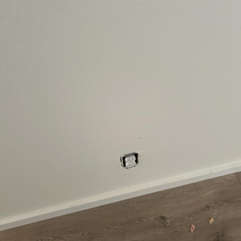 Receptacle box missing cover plate on wall near floor Receptacle box missing cover plate on wall near floor
