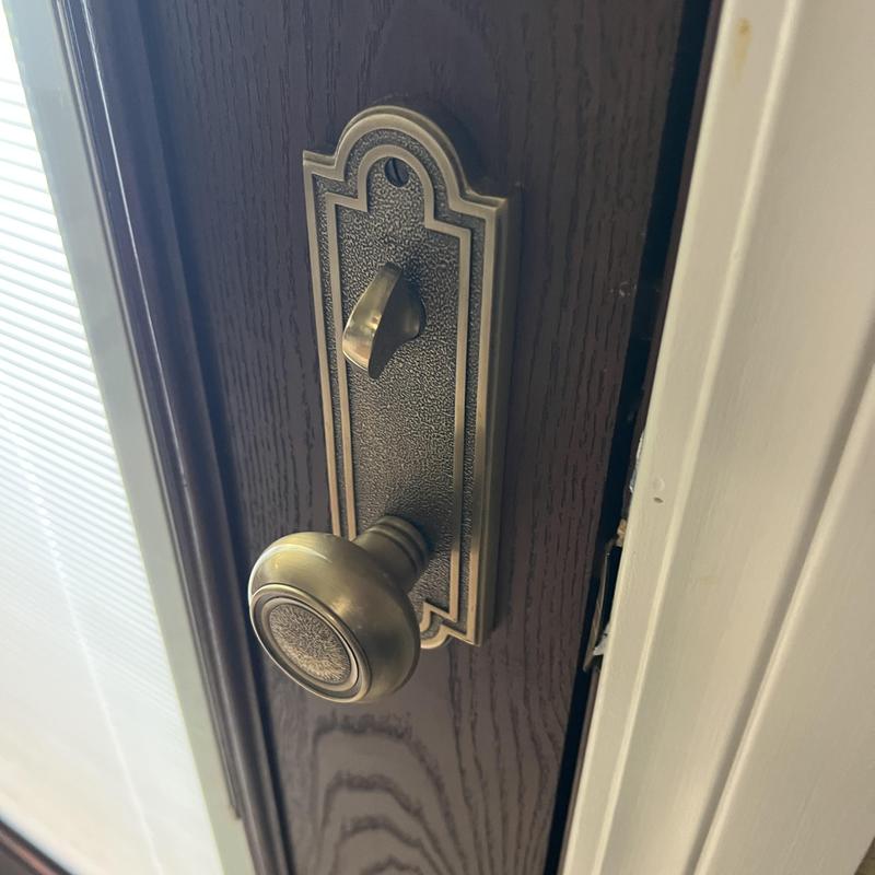 Emtek handle set and back door lock on wood door