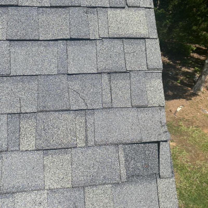 Asphalt roof shingles with hail and wind damage