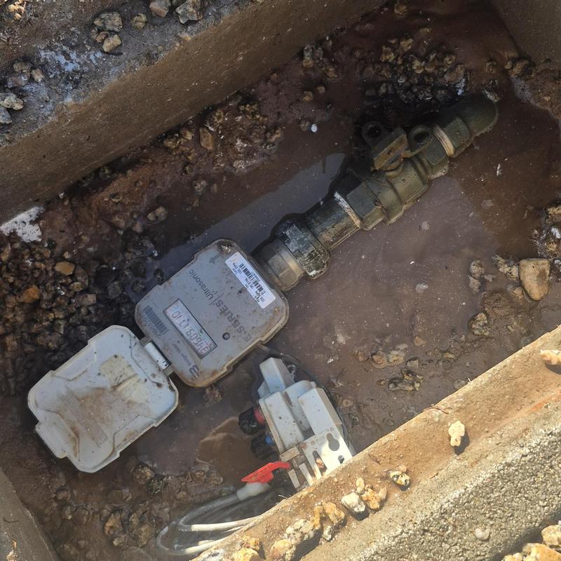 Water meter valve in muddy ground box in Glendale, AZ
