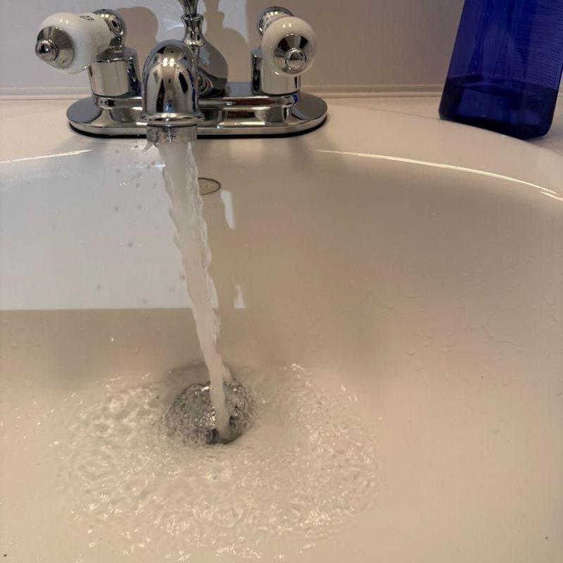 Chrome pop up drain with overflow in bathroom sink Chrome pop up drain with overflow in bathroom sink