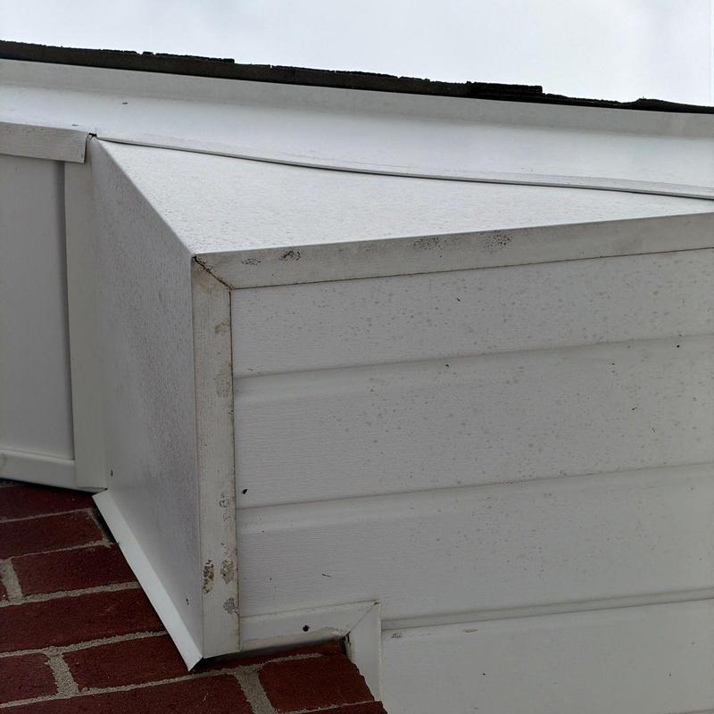 Roof flashing and vinyl siding junction with dirt marks