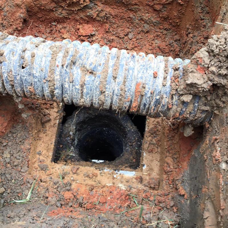 Septic tank access pipe with surrounding soil excavation Septic tank access pipe with surrounding soil excavation