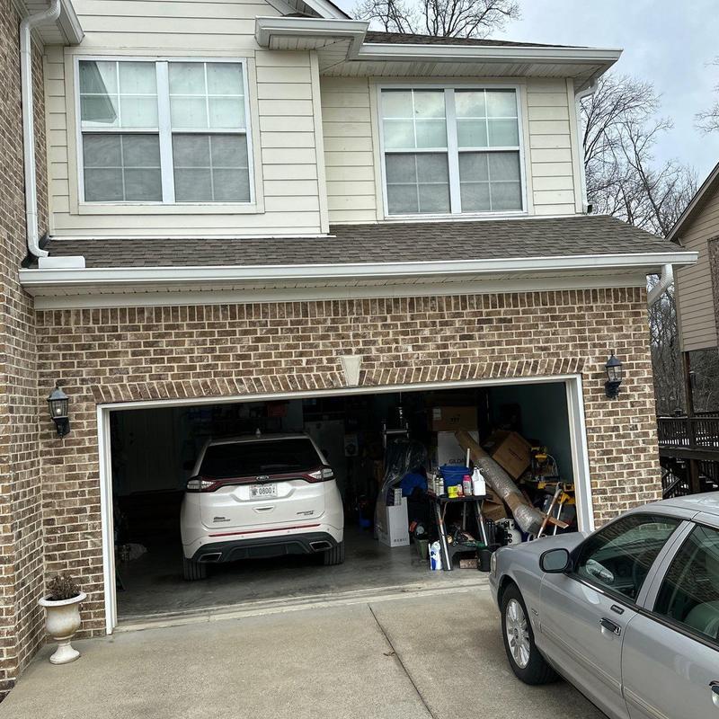 Garage door with vehicles and stored items inside