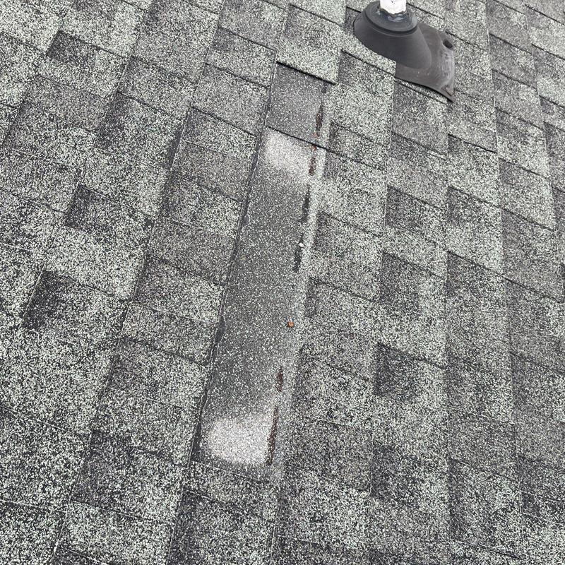 Asphalt shingle roof with visible hail damage and wear