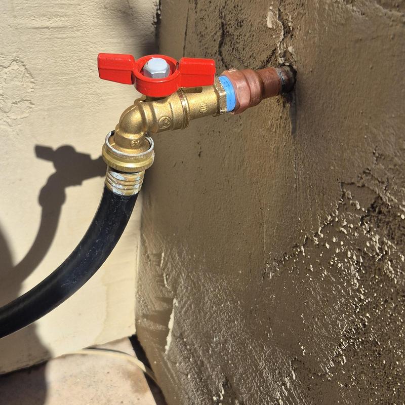 Outdoor hose bib with red valve handle