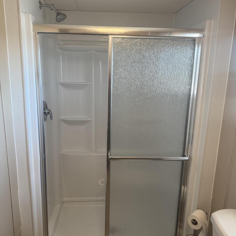 Shower enclosure with frosted sliding glass doors Shower enclosure with frosted sliding glass doors