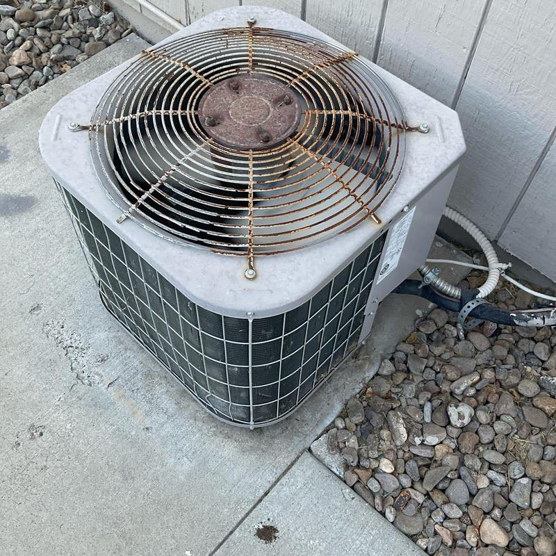 Air conditioner condenser unit with rusted fan guard Air conditioner condenser unit with rusted fan guard