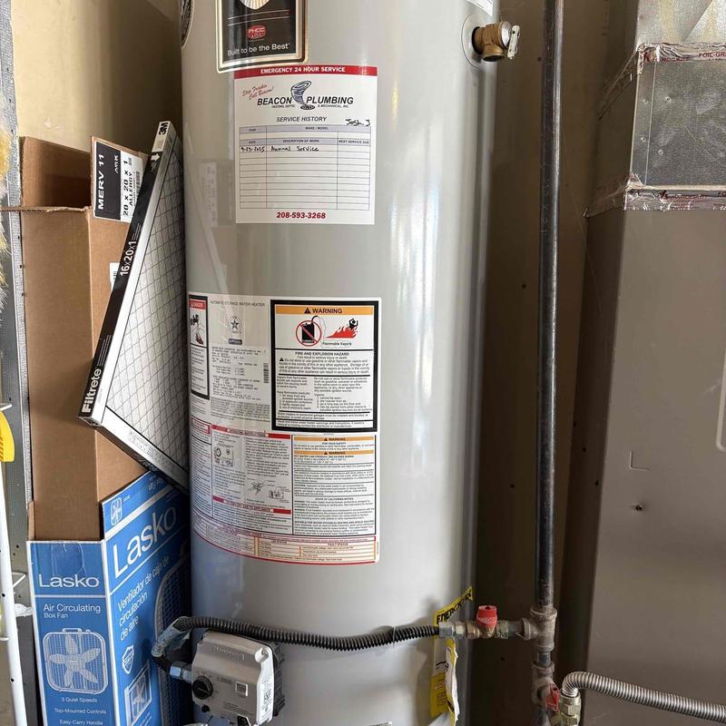Water heater with Beacon Plumbing annual service sticker Water heater with Beacon Plumbing annual service sticker