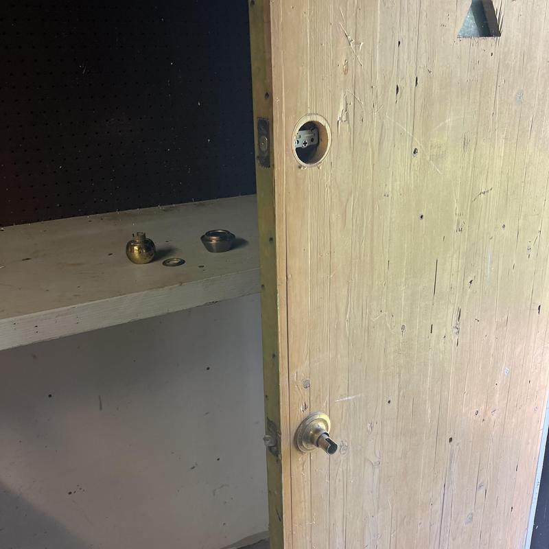 Door knob lock with removed hardware pieces