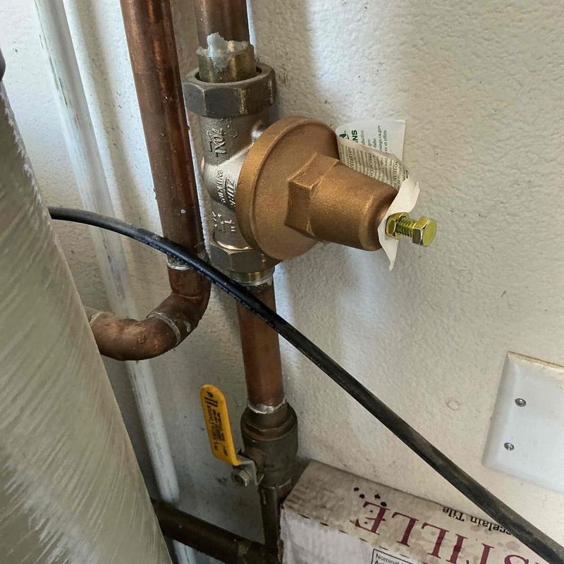 Pressure regulator on copper plumbing lines near valve