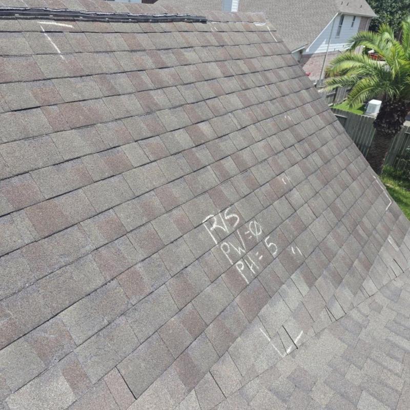 Asphalt shingle roof with hail damage markings in Pearland