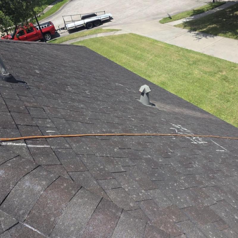 Asphalt shingle roof with hail damage marks