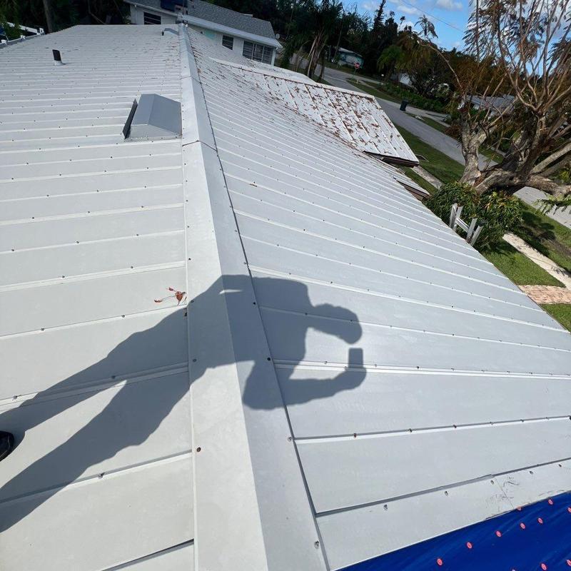 Metal roof panels with rust and loose fasteners Metal roof panels with rust and loose fasteners