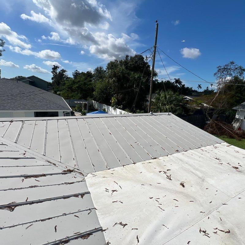 Metal roof panel transition with open seams and debris Metal roof panel transition with open seams and debris
