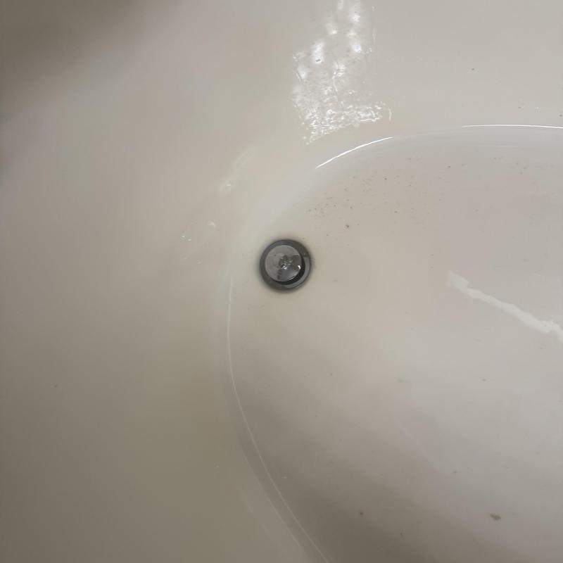 Tub drain replacement in white bathtub basin