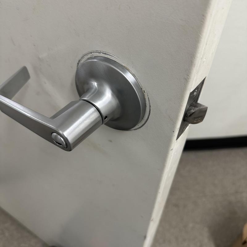 Bathroom door lever lock on white door interior