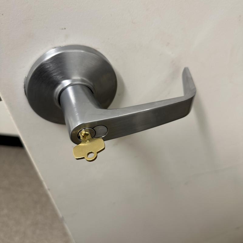 Bathroom door lock with key in retail store door