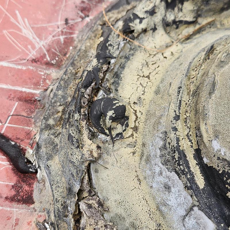 Metal roof chimney seal with cracked and peeling coating