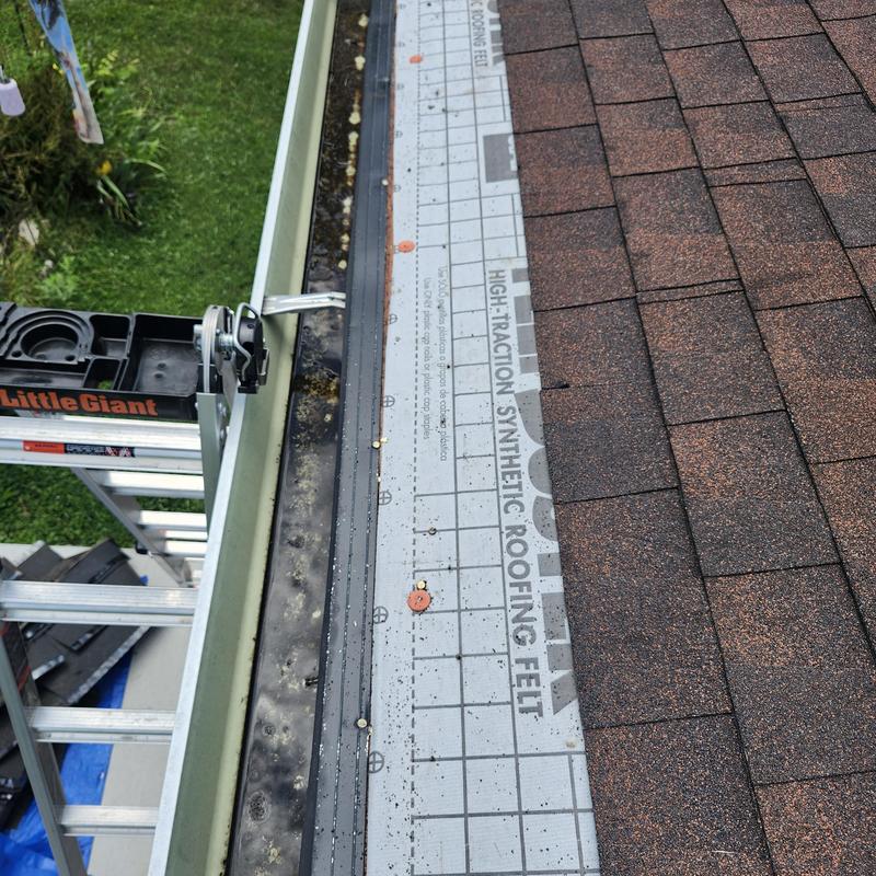 Synthetic roofing felt installation on shingled carport roof