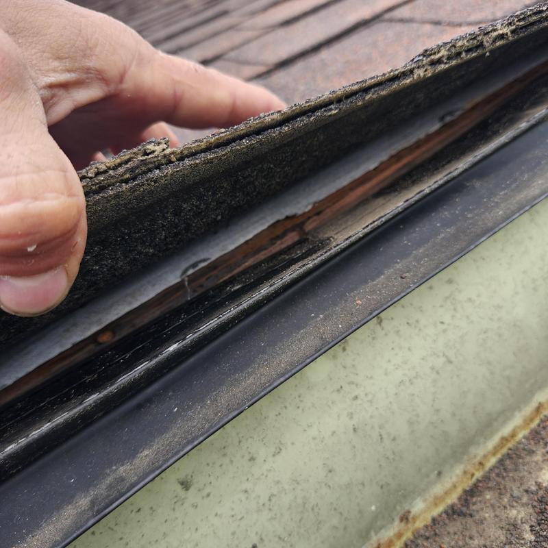 Carport shingle layers lifted to inspect leak