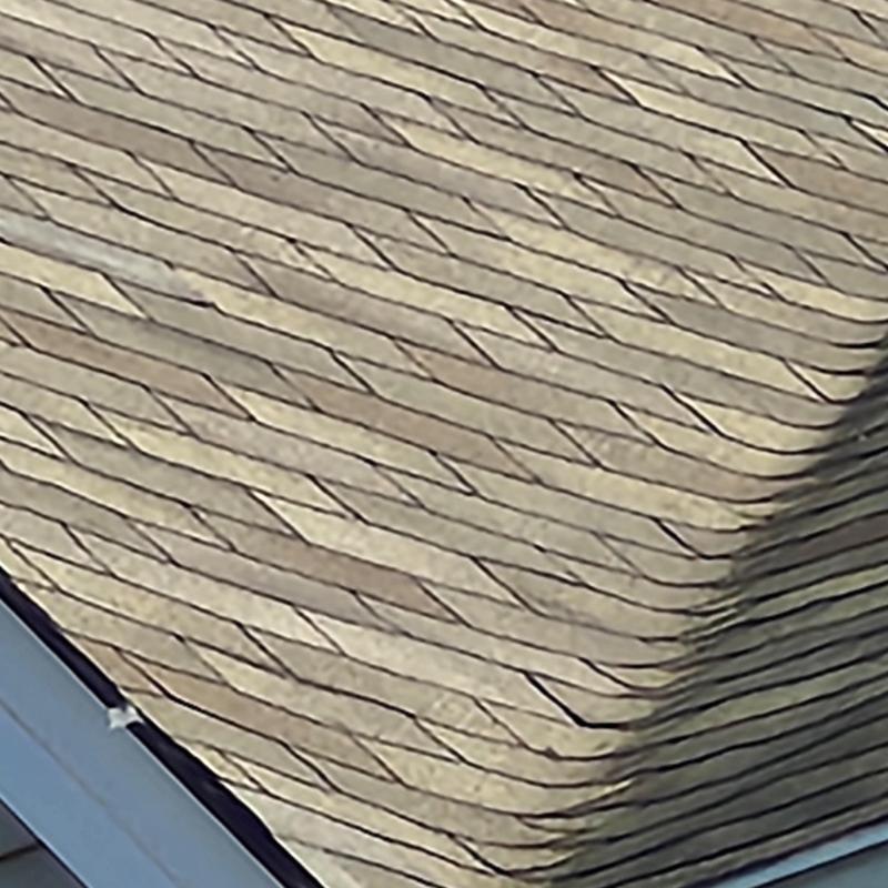 Roof shingles with several missing pieces near edge