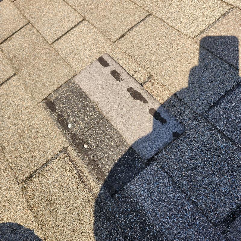 Roof shingles with missing and damaged spots