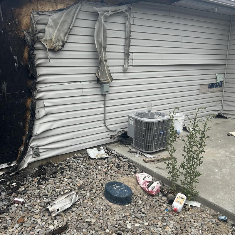 HVAC unit and burned siding damage at apartment exterior HVAC unit and burned siding damage at apartment exterior