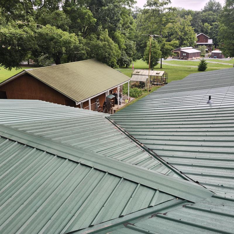 Metal roof with damaged soffit and fascia after limb fell